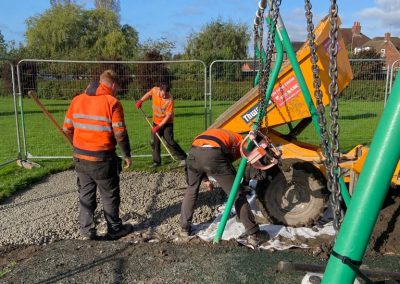 Dumper tipping concrete sub base before bonded rubber mulch